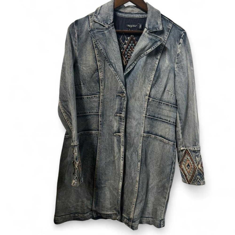 Blue denim jacket with embroidered sleeves, featuring a boho western vibe‎